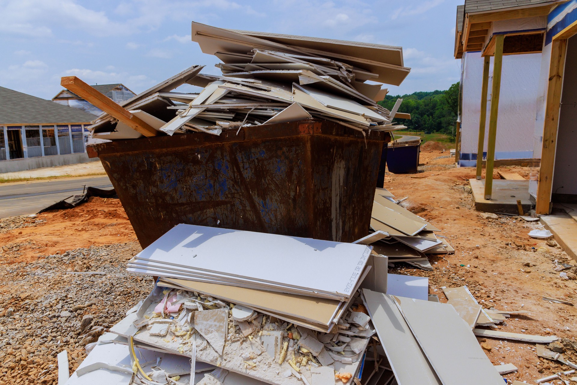 Remains of plasterboard drywall were placed in a construction waste container